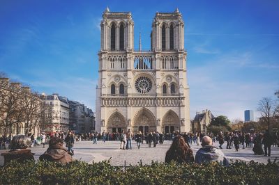 Group of people in historic building against sky