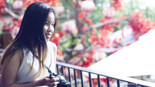 Portrait of smiling young woman looking away