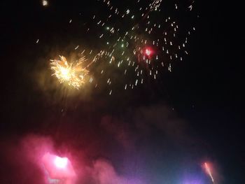 Low angle view of firework display at night