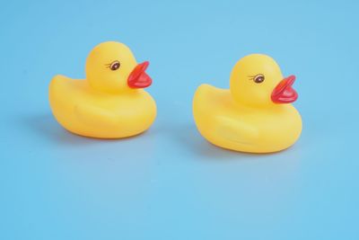 Close-up of yellow toys against blue background