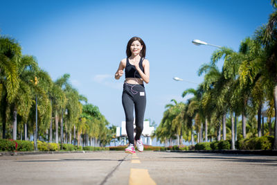 Full length of woman on footpath against sky
