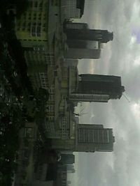 Low angle view of buildings against cloudy sky