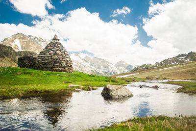 Scenic view of lake and mountains against sky