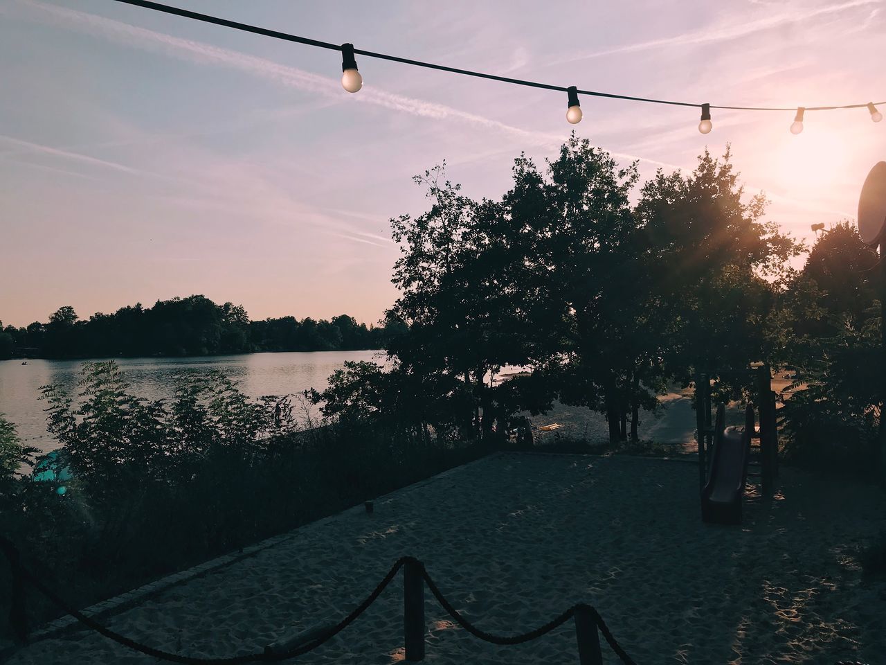 SILHOUETTE TREES BY LAKE AGAINST SKY DURING SUNSET