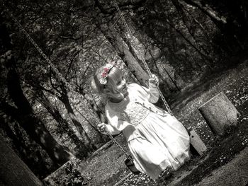 Young woman with umbrella on tree