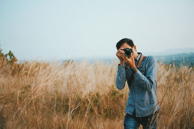 Man wearing sunglasses standing on field