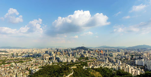 High angle view of buildings against cloudy sky