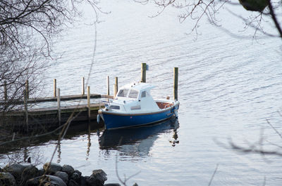 Sailboats moored in lake during winter