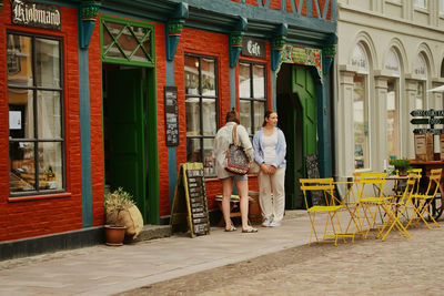 People at entrance of building in city