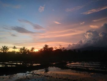 Scenic view of lake against sky during sunset