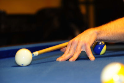 Person playing a game of billiard at the pool table