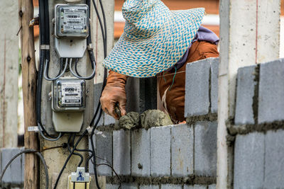 Low section of man standing on hand holding camera