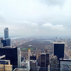 Cityscape against cloudy sky