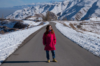 Portrait of woman walking on road