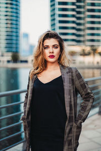 Beautiful young woman standing in city