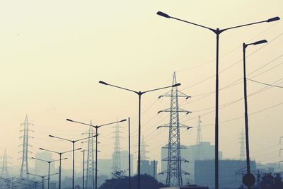 Low angle view of street lights against sky during sunset