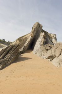 Low angle view of rock formation against sky