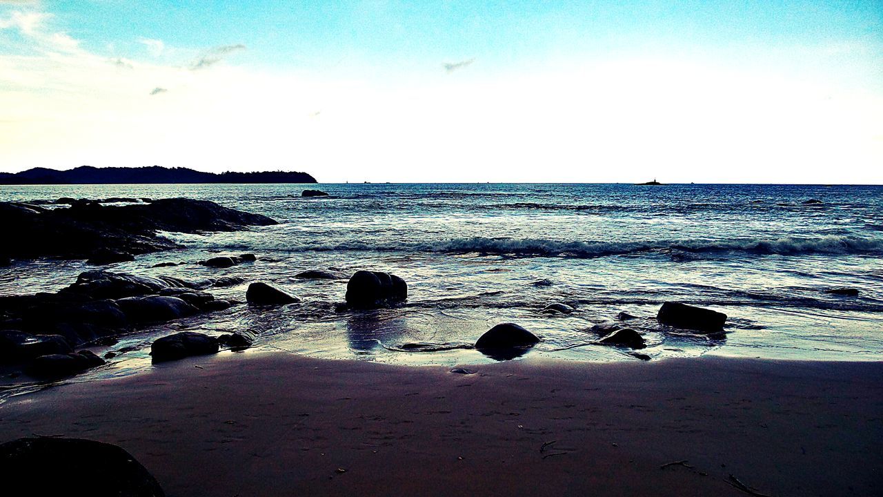 Sandy beach with big stones