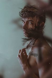 Portrait of young man standing in water