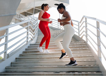 Full length of woman walking on staircase