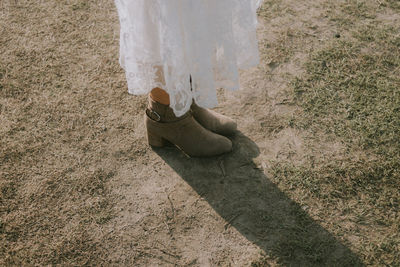 Low section of woman standing on ground