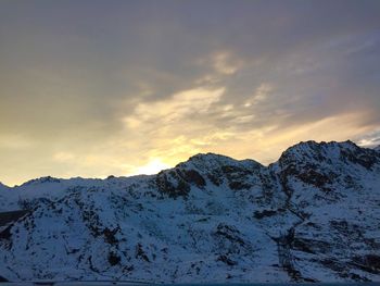 Scenic view of snowcapped mountains against sky during sunset