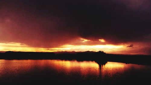 Scenic view of lake against sky during sunset