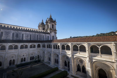 Low angle view of historical building against clear blue sky