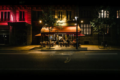 Illuminated city by street at night