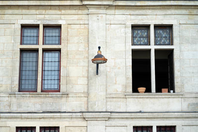 Low angle view of electric lamp on building