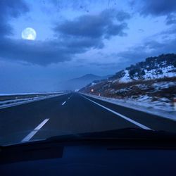 Aerial view of illuminated road against sky at night