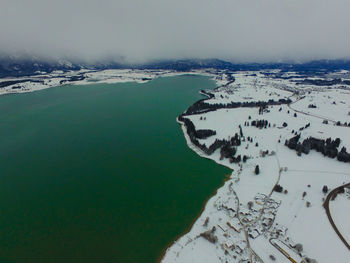 Scenic view of lake against sky during winter