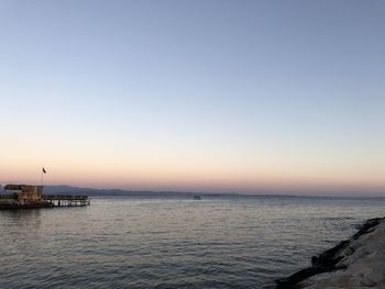 Scenic view of sea against clear sky during sunset