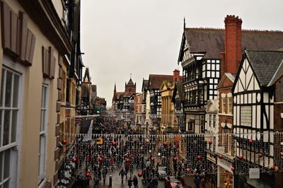 High angle view of people on street amidst buildings in city