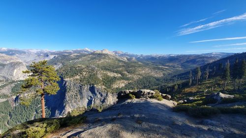 Scenic view of mountains against blue sky