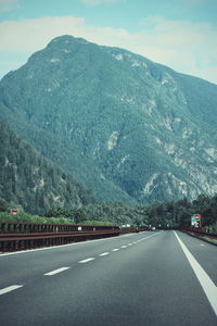 Empty road leading towards mountains