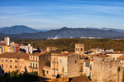 Buildings in town against sky