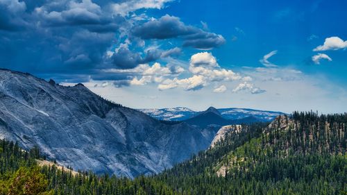 Scenic view of snowcapped mountains against cloudy sky