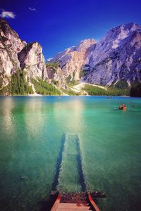 Scenic view of sea and mountains against sky