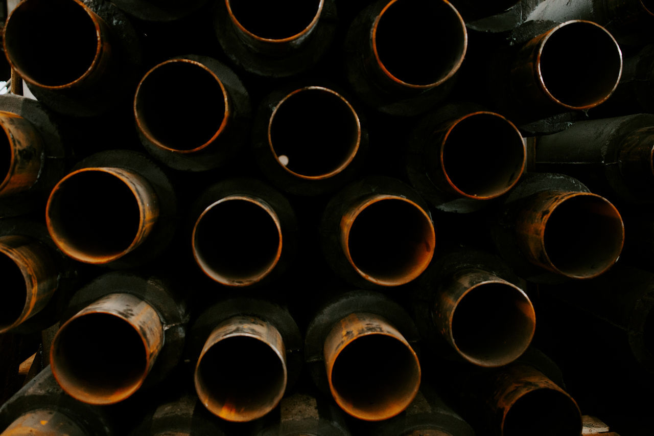 FULL FRAME SHOT OF STACK OF PIPE