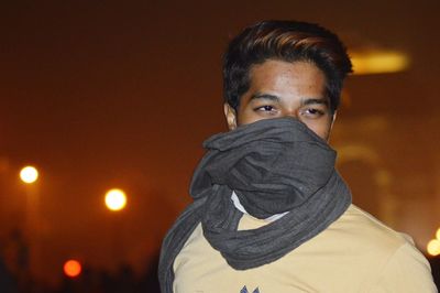 Young man against with scarf at night