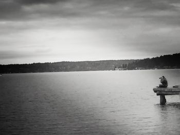 Scenic view of lake against cloudy sky