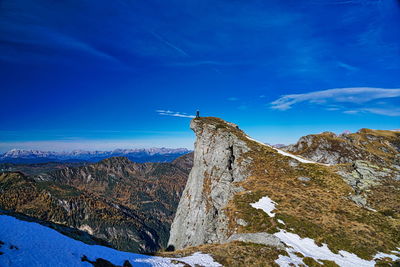 Scenic view of snowcapped mountains against blue sky