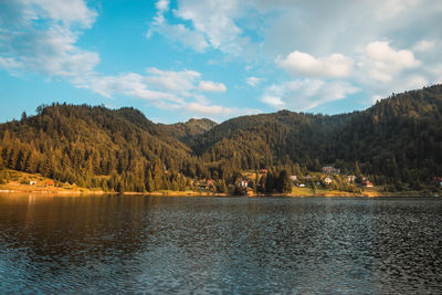 Scenic view of lake and mountains against sky