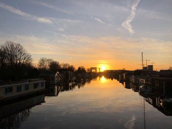 Scenic view of river against sky at sunset