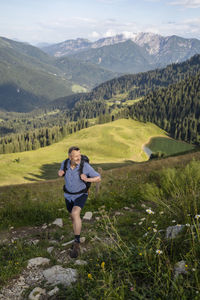 Full length of man standing on landscape against mountains