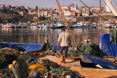 Boats moored in river against built structures