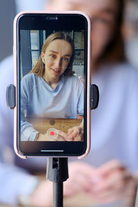 Midsection of woman using mobile phone