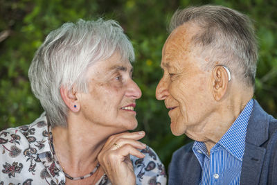 Portrait of man with woman standing outdoors