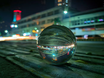 Close-up of illuminated light on street at night
